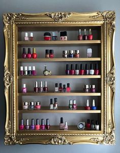 an ornate gold framed display with nail polish bottles