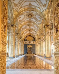 an ornate hallway with gold and white walls