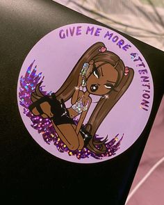 a sticker that says give me more attention on the back of a laptop computer