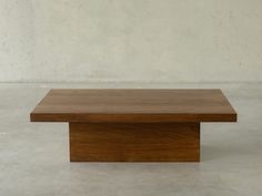 a wooden table sitting on top of a white floor