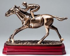 Bronze statue of a race horse & jockey in the middle of a race mounted on a rosewood base. Trophy Stand, Wars Of The Roses, Kentucky Derby Party, Derby Party, Bronze Statue, Kentucky Derby