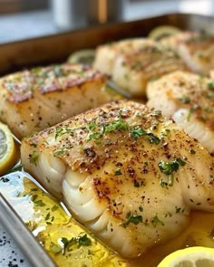 some fish with lemon slices and seasoning on them