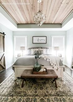 an image of a bedroom with a bed and chandelier in the middle of it