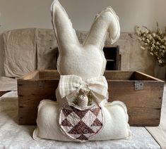 a stuffed bunny sitting on top of a pillow