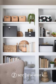 a white book shelf filled with lots of books and other items on top of it