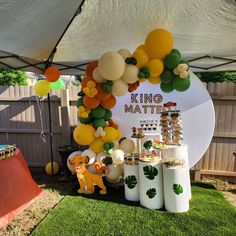 a party setup with balloons and decorations for a lion themed birthday