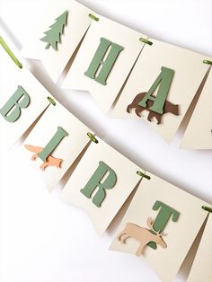 the letters are made out of paper and have animals hanging from it's sides