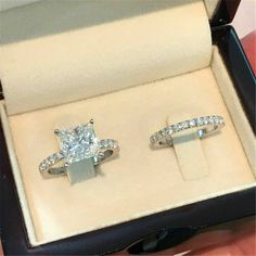 two engagement rings in a box on display