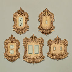 four ornate light switch plates are shown in this set of five wall decor pieces, each with an intricately carved frame and two toggles