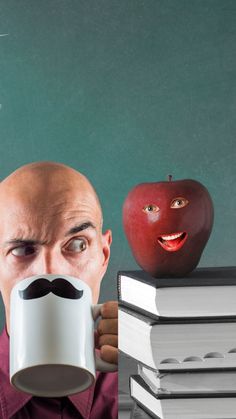 a man with a moustache holding a coffee mug in front of his face