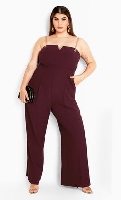 The sleeveless design and wide leg full length trousers of our Ann Chain Jumpsuit are expertly tailored to fit your curves! Designed with a lined bodice, feel comfortable as you dazzle eyes wherever you go! Key Features Include: - Straight neckline with V cut out - Removable gold chain straps - Sleeveless design - Invisible zipper back closure - Wide leg full length trousers - Lined bodice Partner with metallic-hued heels! | Plus Size Ann Chain Jumpsuit in Oxblood, Size 14 | City Chic Red Carpet Jumpsuit, Plus Size Red Carpet, Heels Plus Size, Gold Jumpsuit, Chic Party, Straight Neckline, Plus Size Jumpsuit, V Cut, City Chic