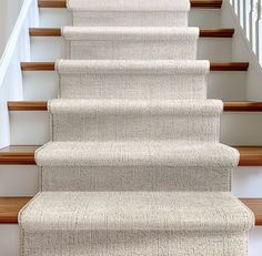 a carpeted staircase leading up to the second floor