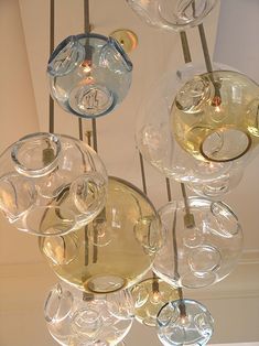 a chandelier made out of wine glasses hanging from the ceiling