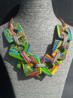 a multicolored necklace is displayed on a mannequin's neckline