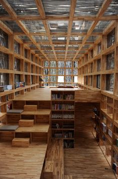 an empty library with lots of bookshelves and wooden flooring is seen in this image