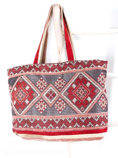 Whether you're going to the beach, or going just for a walk, Our Berber Bags got you covered. They are stylish, yet spacious enough to hold your essentials. Our handmade bags are made by skilled women in the Atlas Mountains in Morocco using only the highest quality materials. With attention to detail and quality that stands the test of time.  The bags are handcrafted from a beautiful woven fabric, 100% cotton that is lightweight, yet durable and elegant.  The bag has no zip for easy access to your items. It is lined inside and offers one large pocket.  Measurements: Width- 62 cm Height- 42 cm Handle Height- 34cm To get back to my shop, click here: https://www.etsy.com/uk/shop/LamiasBerberHome Say Hi on Instagram @lamiasberberhome Bohemian Bags With Removable Pouch For Vacation, Beach Tote Hobo Bag With Removable Pouch, Bohemian Pouch Beach Bag For Travel, Bohemian Beach Bag With Removable Pouch For Shopping, Summer Travel Hobo Bag With Removable Pouch, Bohemian Pouch Beach Bag For Shopping, Summer Beach Bag With Removable Pouch, Natural Beach Bag With Removable Pouch For Travel, Red Shoulder Bag With Removable Pouch For Beach