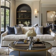 a living room filled with lots of furniture and decor on top of a coffee table