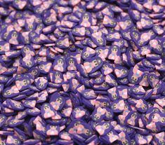 a pile of purple and pink buttons on top of each other in the shape of hearts