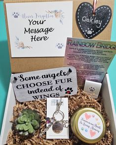 an open box with various items inside it on a blue tablecloth and two greeting cards