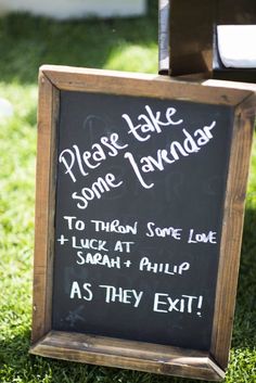 a chalkboard sign that says please take some lavender to throw some love luck at an alohp as they exit