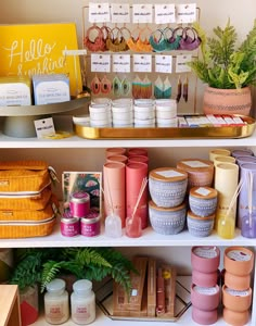 the shelves are filled with candles and other items