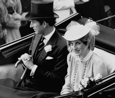 a man and woman sitting in the back of a car with hats on their heads