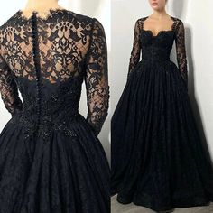 a black dress with long sleeves and lace