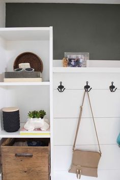 a white shelf with two purses on it and some other items in the background