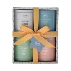 three candles in a gift box with a bow