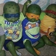 three baby turtles dressed in t - shirts and bandannas sitting next to each other