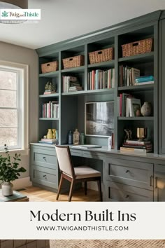 an office with built in bookshelves, desk and chair next to a window