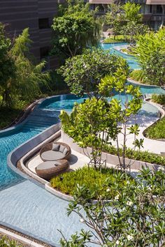 an outdoor swimming pool surrounded by trees and bushes