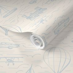 an image of a wallpaper with blue and white designs on the paper, which is rolled up