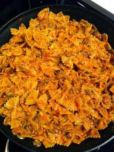 a pan filled with pasta on top of a stove