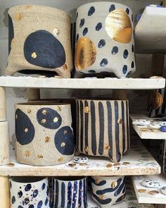 many different vases are stacked on shelves