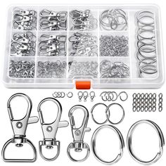 an assortment of metal hardware and accessories in a plastic container with clippings on the side