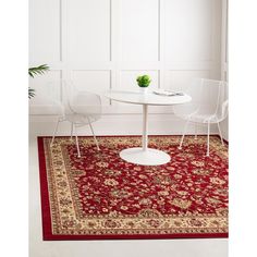 a white table with two chairs and a red rug