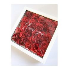 a white box filled with red roses and the words i love you written on it