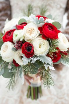 a bridal bouquet with red, white and green flowers