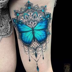 a woman's thigh with a blue butterfly on it