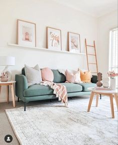 a living room filled with lots of furniture and pictures on the wall above it's couch