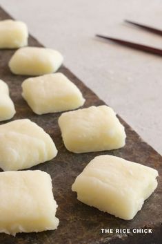 several pieces of food sitting on top of a cutting board