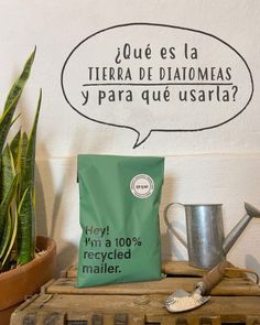 a coffee bag sitting on top of a wooden crate next to a potted plant