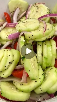 a bowl filled with cucumber, onions and red onion salad on top of a table