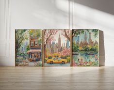 three canvases with city scenes painted on them in an empty room next to a wooden floor