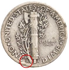 an old silver coin with a red marker on it