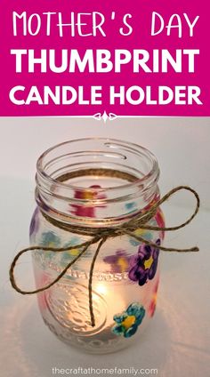 a mason jar filled with flowers and the words mother's day thumbprint candle holder