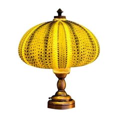 an old fashioned lamp with a yellow shade on it's base and a black top