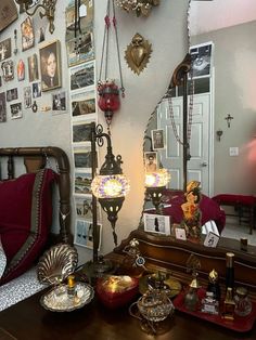 a room filled with lots of antique items on top of a wooden table in front of a mirror