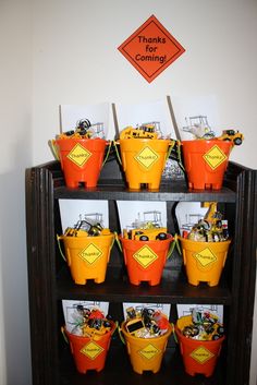 there are many orange buckets on the shelf